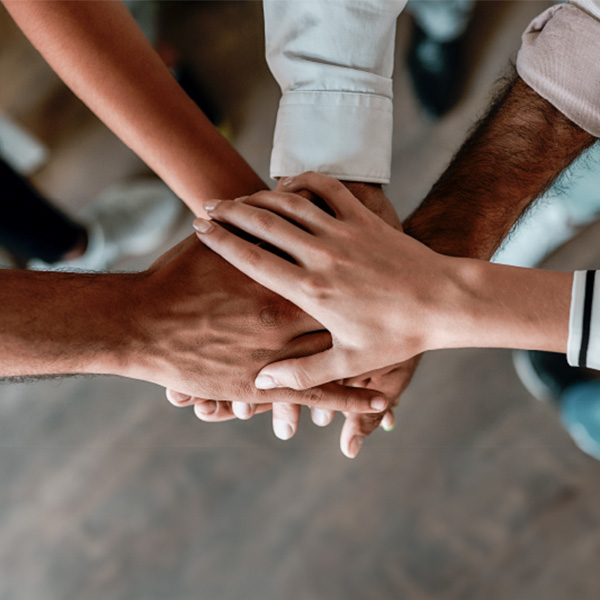 A group of hands stacked on top of each other.